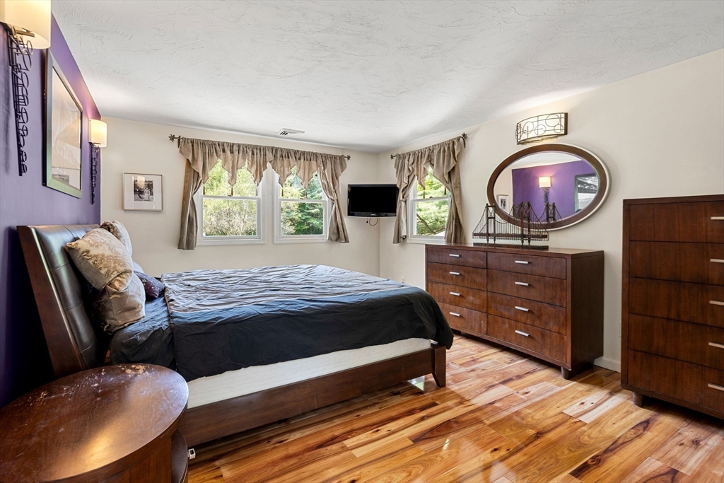 49 Parker Road Shirley, MA 01464 - Photo 26 of 42 a bedroom with a bed and a flat screen tv