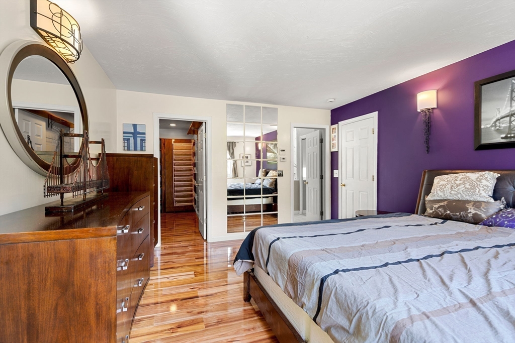 49 Parker Road Shirley, MA 01464 - Photo 27 of 42 a bedroom with a bed a mirror and dresser