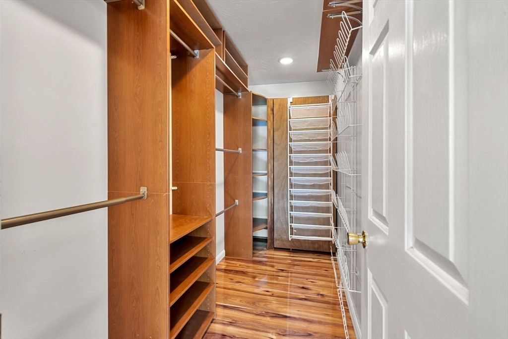 49 Parker Road Shirley, MA 01464 - Photo 28 of 42 a view of a hallway with wooden floor and staircase