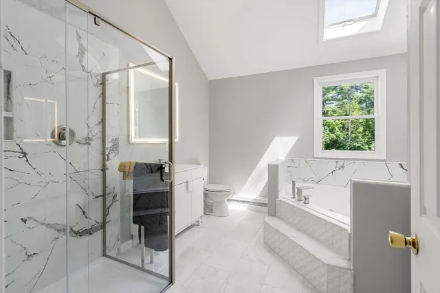 a bathroom with a bathtub and a window