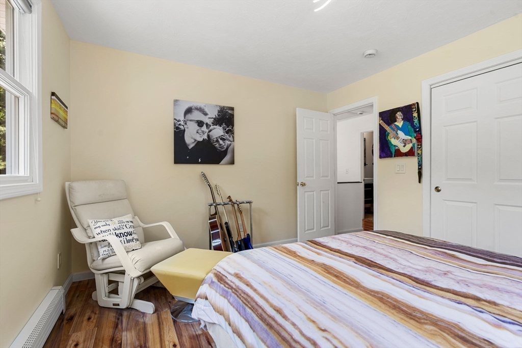 49 Parker Road Shirley, MA 01464 - Photo 32 of 42 a bedroom with a bed and a table in it