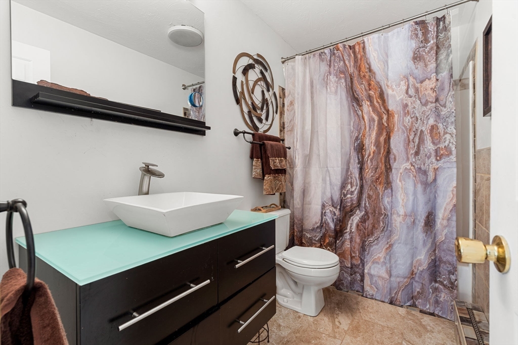 49 Parker Road Shirley, MA 01464 - Photo 33 of 42 a bathroom with a sink a toilet and a mirror