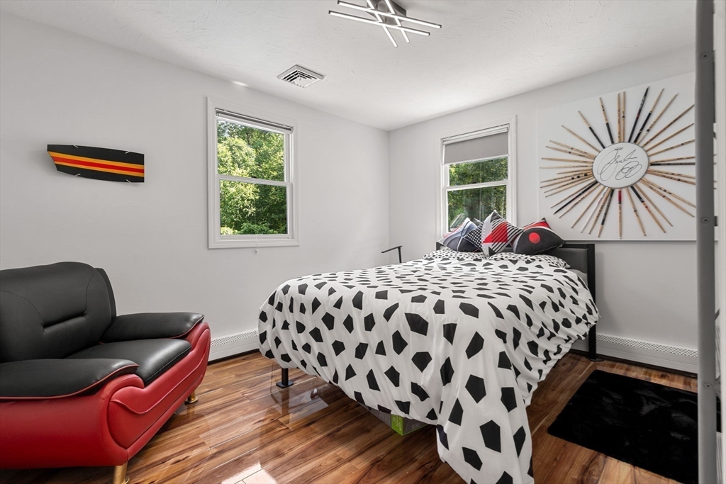 49 Parker Road Shirley, MA 01464 - Photo 34 of 42 a bedroom with a bed and a chair