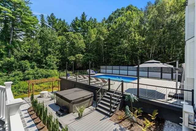 a aerial view of a house with swimming pool next to a yard