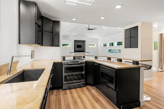 a kitchen with stainless steel appliances a stove sink and microwave