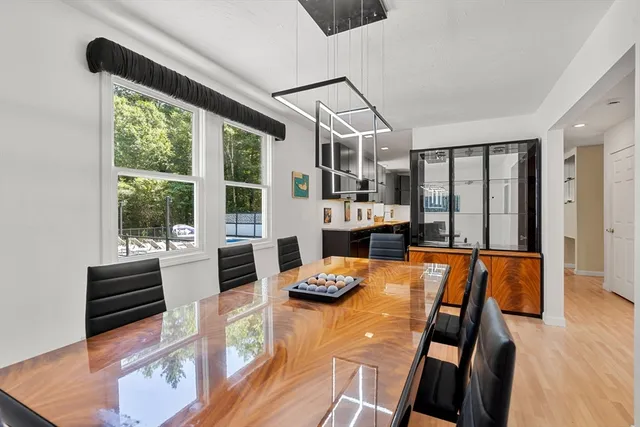 a view of a dining room with furniture a chandelier and wooden floor