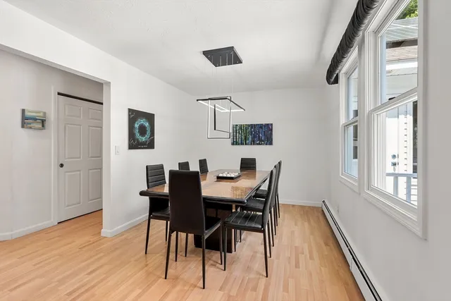 a view of a dining room with furniture and wooden floor