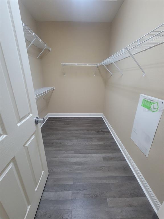 10418 Fenceline Road New Port Richey, FL 34655 - Photo 25 of 36 a view of an empty room with wooden floor and a window