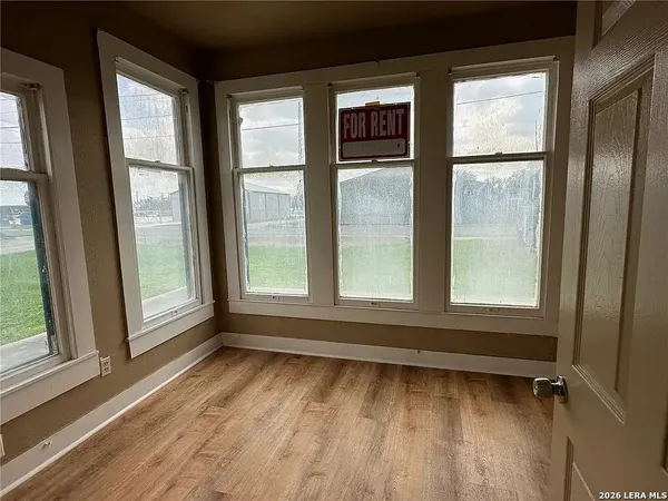 a view of wooden floor and windows in a room