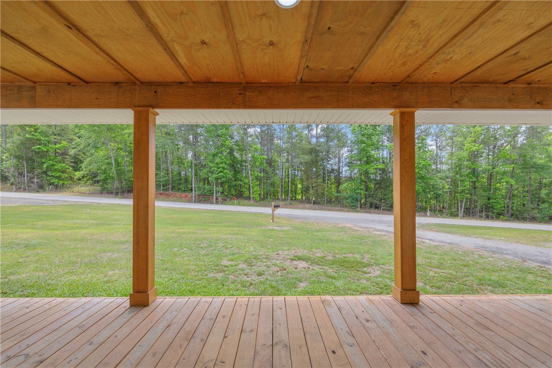 3030 Smith McGee Road Iva, SC 29655 - Photo 5 of 46 Enjoy tranquil woodland views from this inviting covered front porch, offering a perfect outdoor retreat.