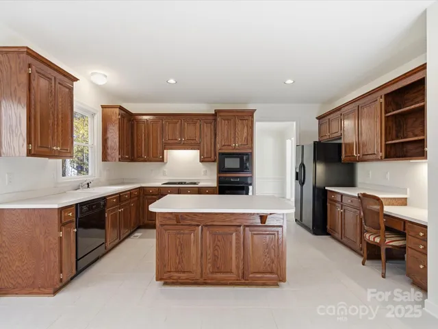 a kitchen with stainless steel appliances a refrigerator stove microwave and sink