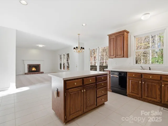 a spacious bathroom with a granite countertop double vanity sink a mirror and a bathtub