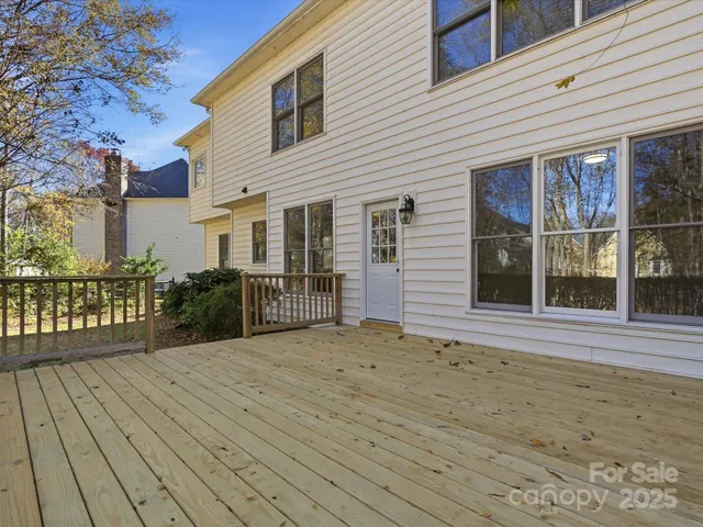 a view of a house with a wooden deck