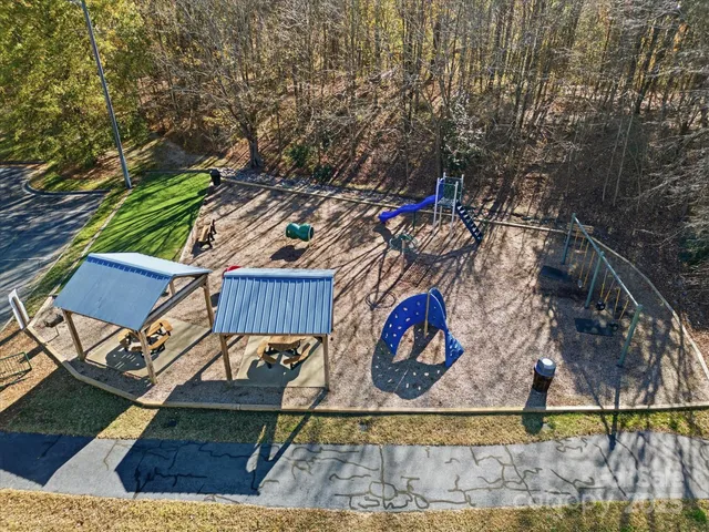 a view of a backyard with wooden fence