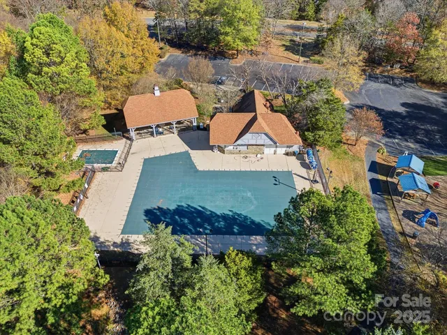 an aerial view of a house with yard