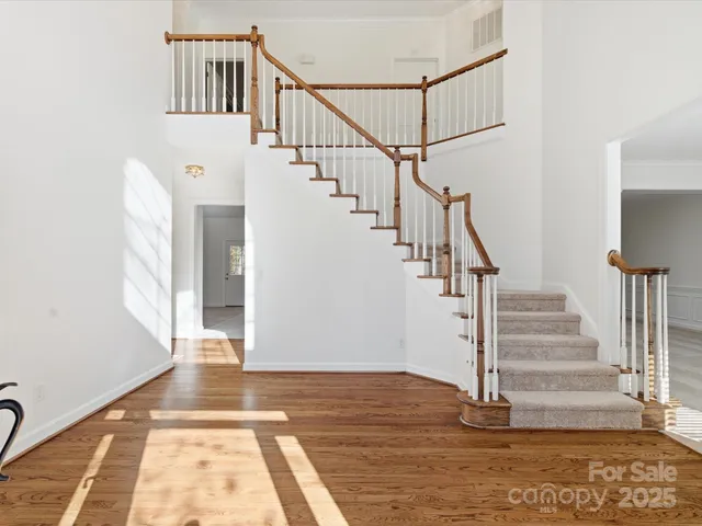 a view of entryway and hall with wooden floor