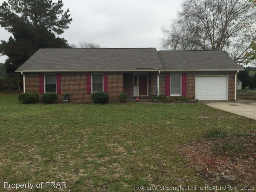 7685 Elliott Bridge Road Spring Lake, NC 28390 - Photo 1 of 26 a brick house next to a yard with potted plants