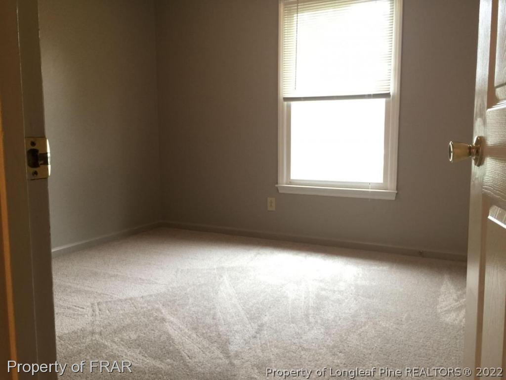 7685 Elliott Bridge Road Spring Lake, NC 28390 - Photo 11 of 26 an empty room with a window