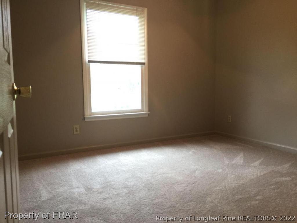 7685 Elliott Bridge Road Spring Lake, NC 28390 - Photo 13 of 26 an empty room with a window