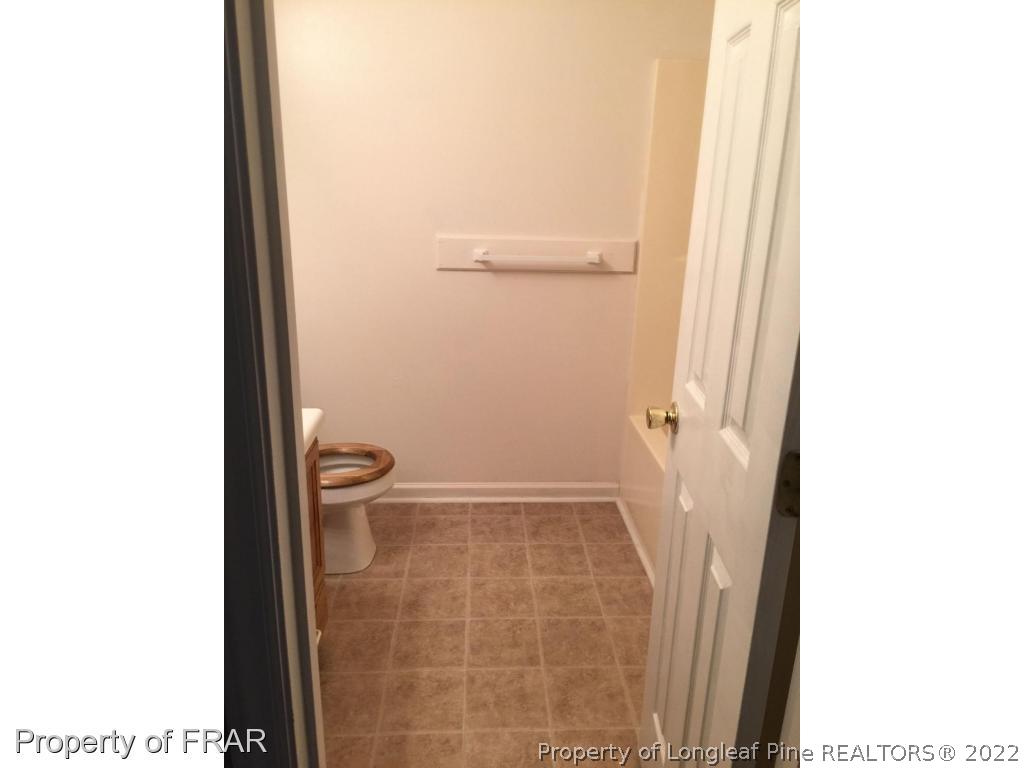 7685 Elliott Bridge Road Spring Lake, NC 28390 - Photo 15 of 26 a bathroom with a toilet and a shower