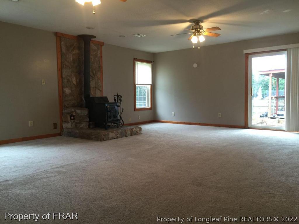 7685 Elliott Bridge Road Spring Lake, NC 28390 - Photo 20 of 26 a view of a livingroom with a ceiling fan and window
