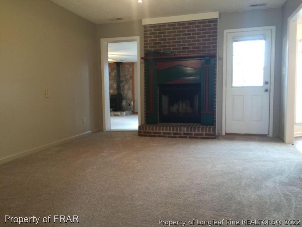 7685 Elliott Bridge Road Spring Lake, NC 28390 - Photo 2 of 26 a view of a livingroom with a fireplace