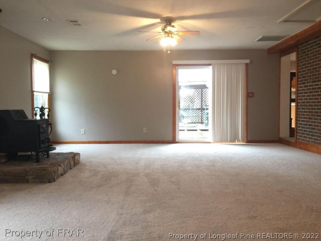7685 Elliott Bridge Road Spring Lake, NC 28390 - Photo 21 of 26 a view of a livingroom with a ceiling fan and window