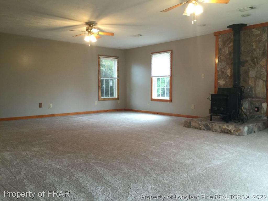 7685 Elliott Bridge Road Spring Lake, NC 28390 - Photo 25 of 26 a view of a room with windows and chandelier fan