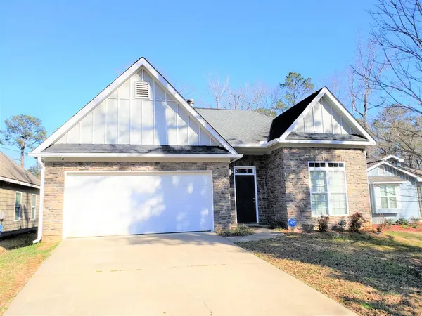 a view of a house with a yard and garage