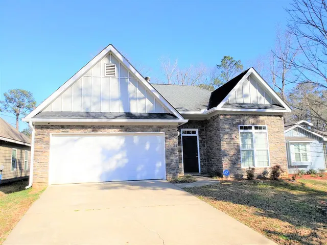 a view of a house with a yard and garage