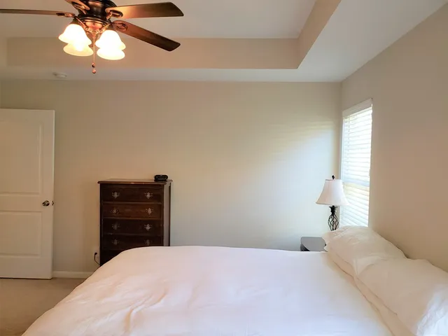 a bedroom with a bed and a chandelier