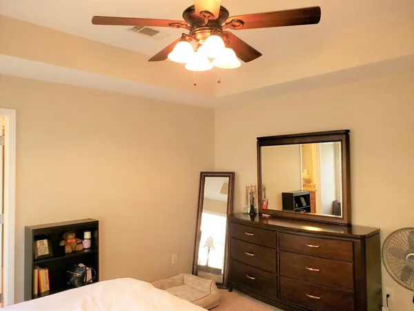 a room with a bed a lamp and a window