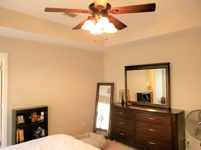 a room with a bed a lamp and a window