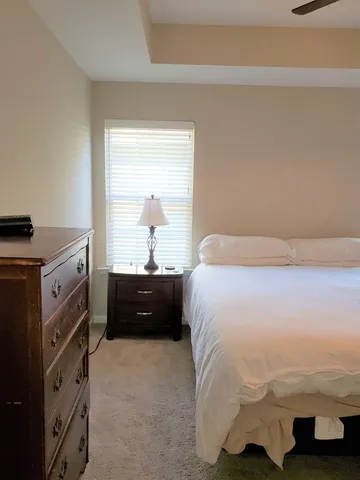 a bed sitting in a bedroom next to a window