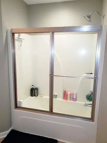 a bathroom with a bathtub and a shower