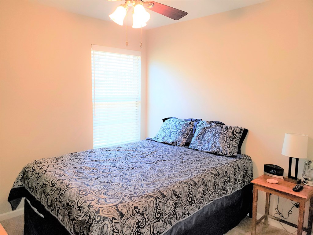 7842 Lloyd Road Columbus, GA 31909 - Photo 21 of 31 a bedroom with a bed and a chandelier