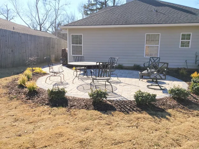 a view of a backyard with chairs