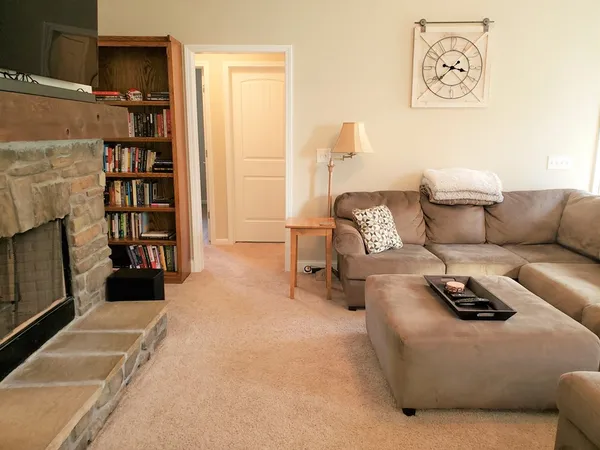 a living room with furniture and a fireplace