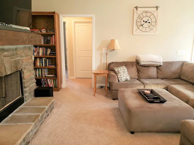 a living room with furniture and a fireplace