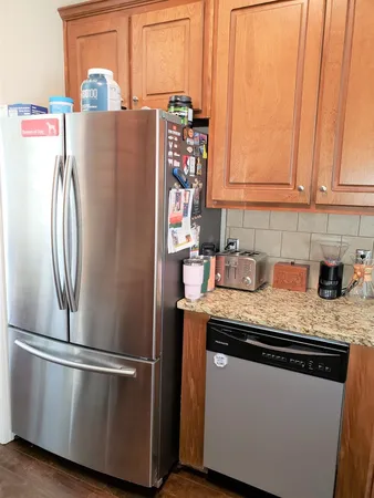 a kitchen with stainless steel appliances granite countertop a refrigerator and a sink
