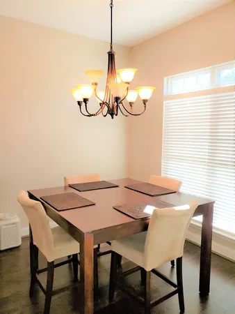 a view of a dining room with furniture and chandelier