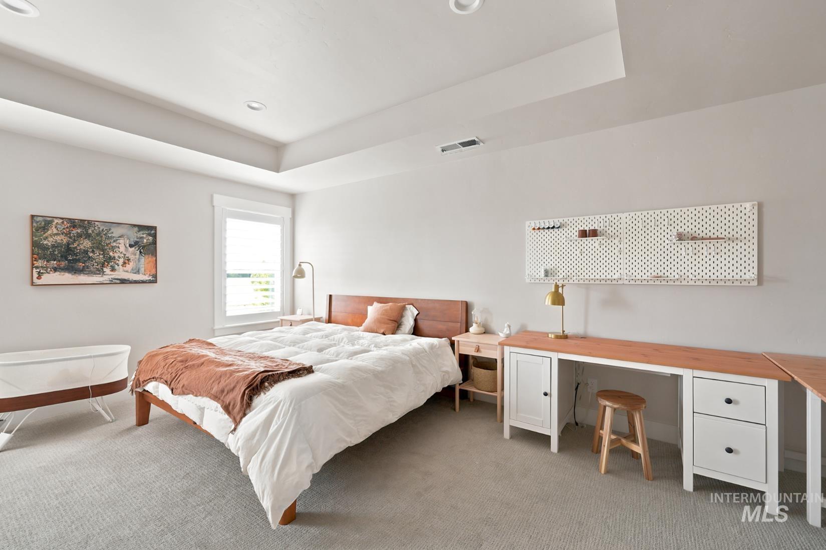 6933 South Zenith Avenue Meridian, ID 83642 - Photo 24 of 34 Bedroom featuring a tray ceiling with recessed lighting, a single window with white trim, and light gray wall paint