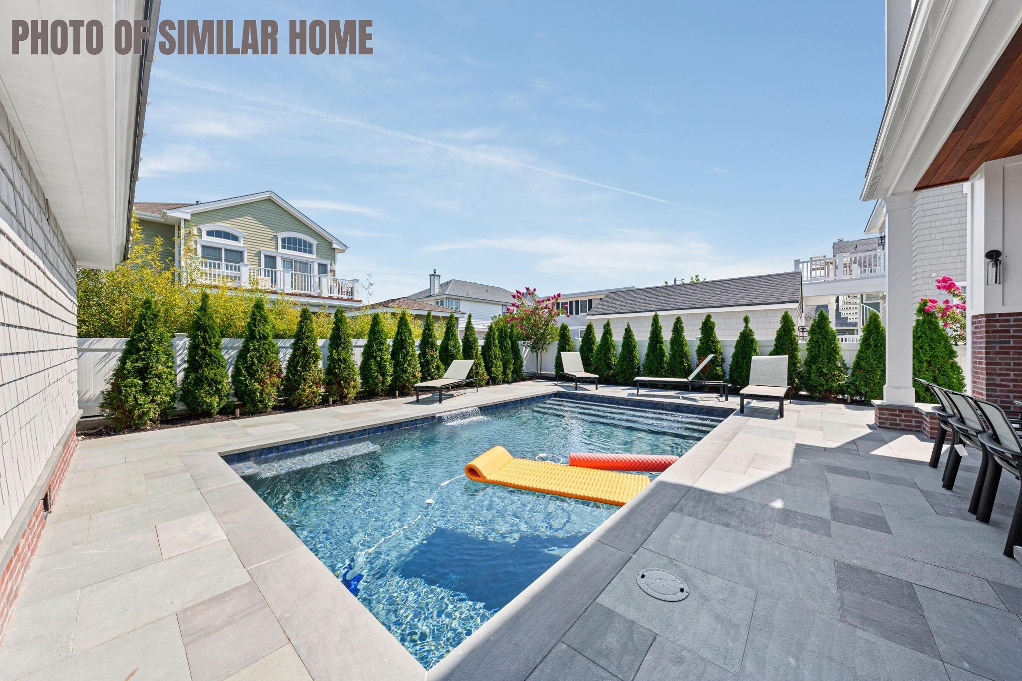 154 98th Street Stone Harbor, NJ 08247 - Photo 35 of 50 a view of swimming pool with outdoor seating and plants