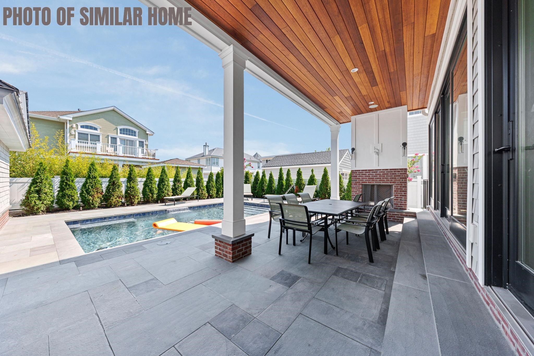 154 98th Street Stone Harbor, NJ 08247 - Photo 37 of 50 a view of a patio with couches table and chairs and potted plants