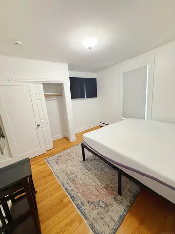 a bedroom with a bed and walk in closet