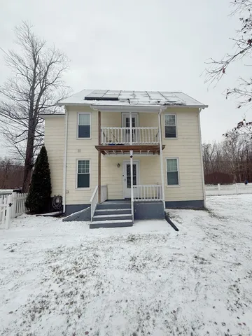 a view of a house with a snow in the yard