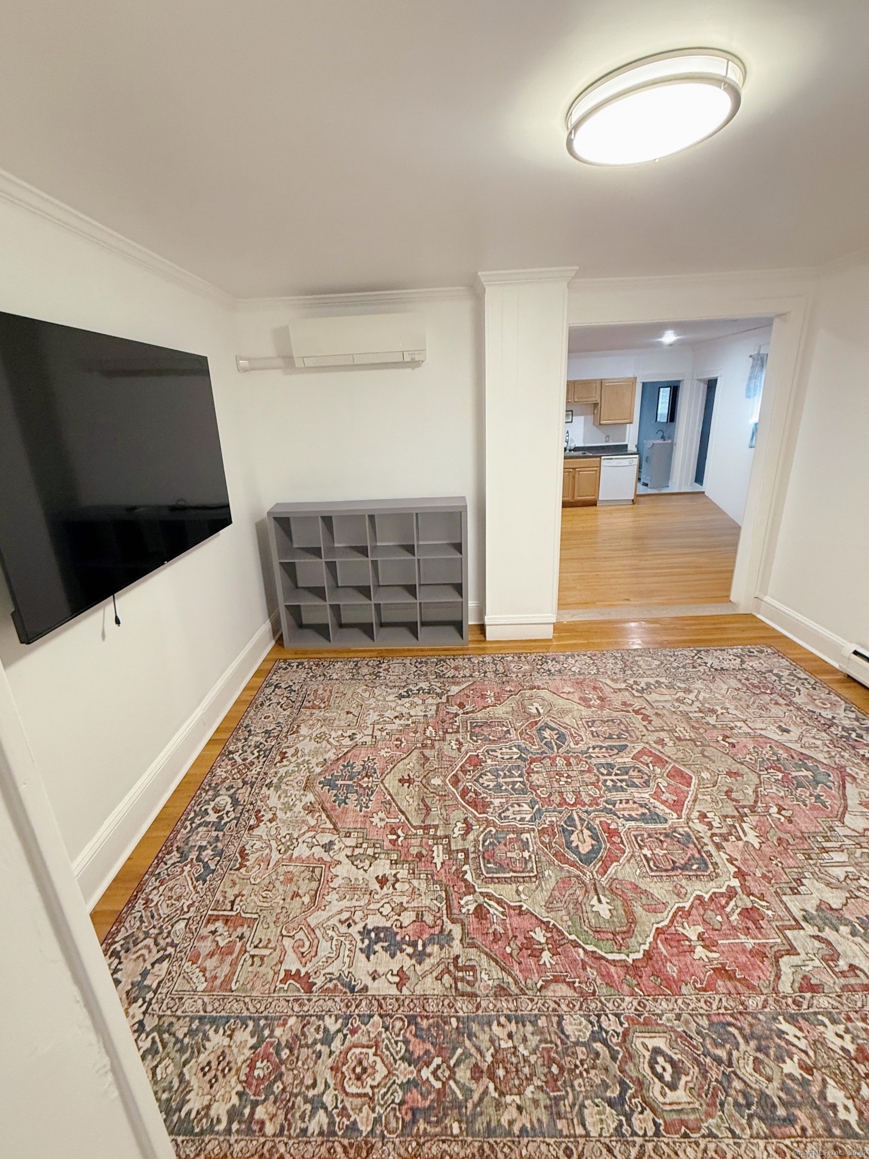 1716 Farmington Avenue Farmington, CT 06085 - Photo 7 of 17 a view of a livingroom with wooden floor and a flat screen tv