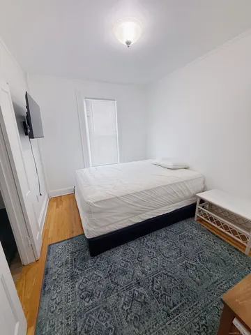 a bedroom with a bed and flat screen tv