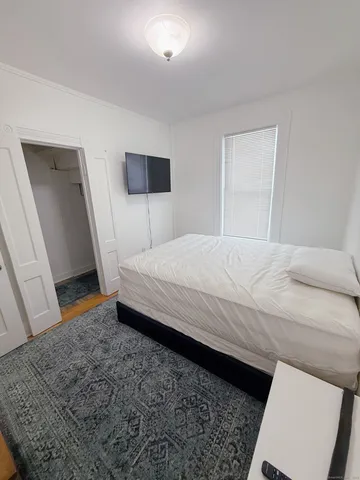 a bedroom with a bed and a dresser