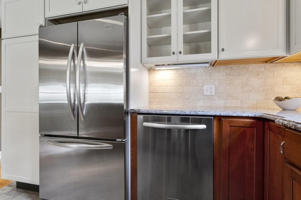 22 Irving Street Reading, MA 01867 - Photo 11 of 37 a kitchen with a refrigerator and a sink